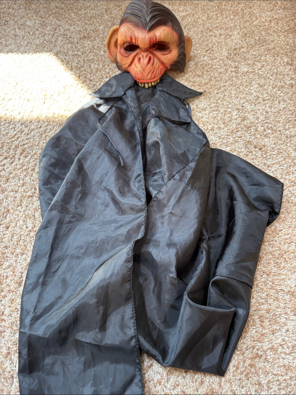 Monkey rubber head costume and black cape